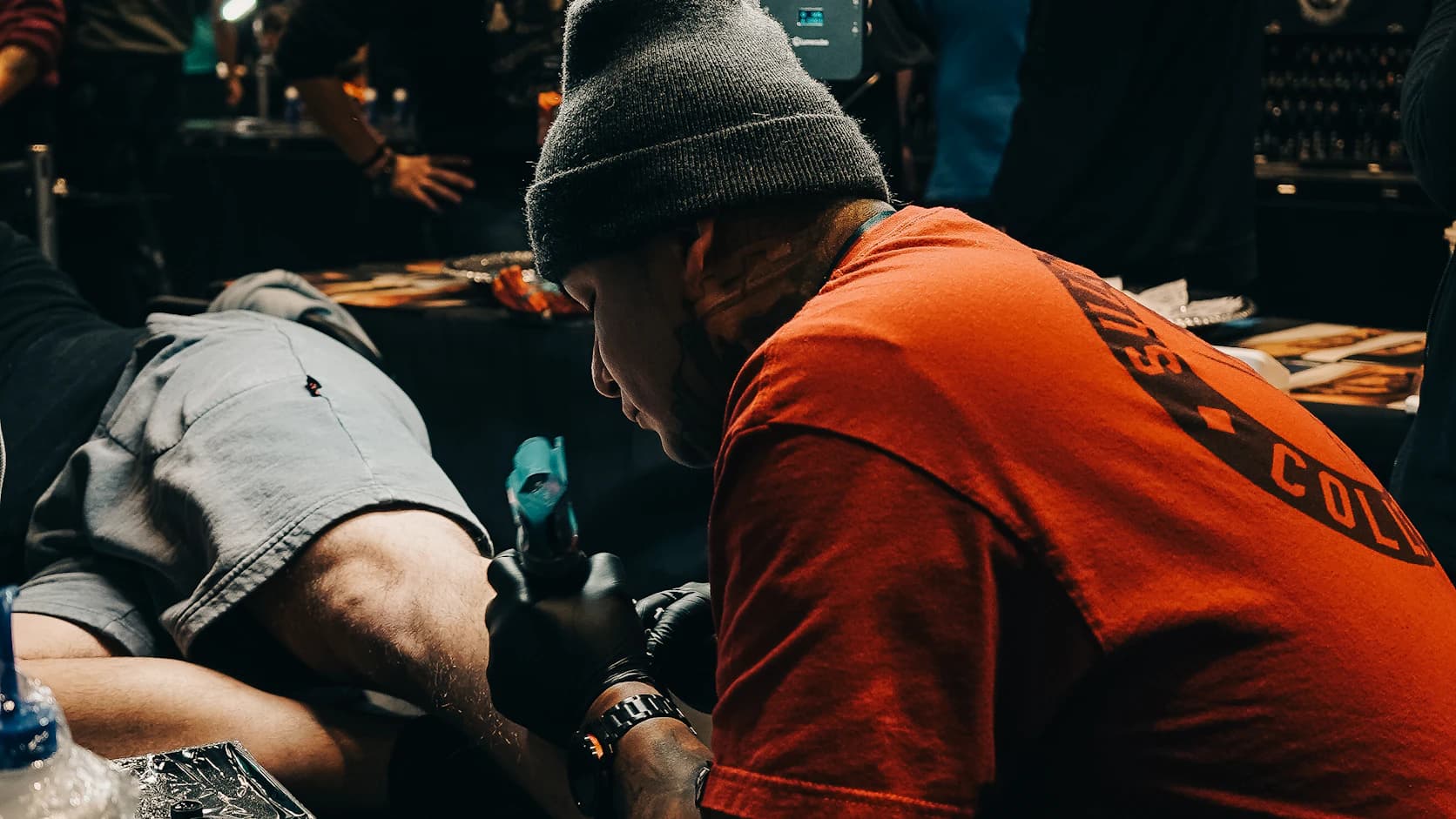 Tattoo artist working under bright studio lights