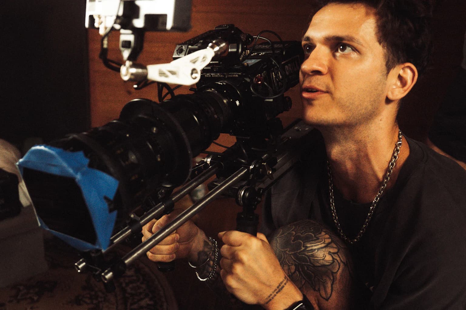 Filmmaker operating a professional camera rig in warm light